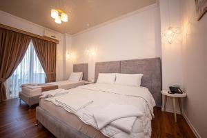 Postel nebo postele na pokoji v ubytování Hotel Murati
