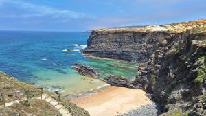 an aerial view of a beach with a cliff at Monte Gaia in Cavaleiro