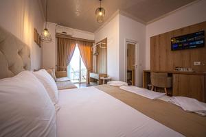 ein Schlafzimmer mit einem großen weißen Bett in einem Zimmer in der Unterkunft Hotel Murati in Ksamil