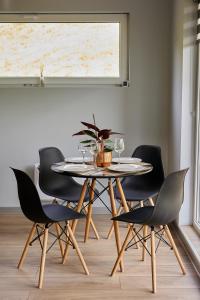 a dining room with a table and four chairs at Copper's Kub in Slănic-Moldova +20 photos