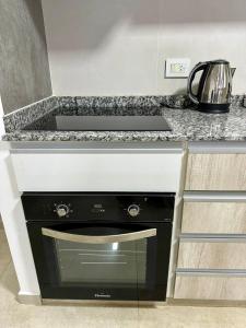 a kitchen with a black dishwasher under a counter at Rio Suits Apartments A in Posadas +22 photos