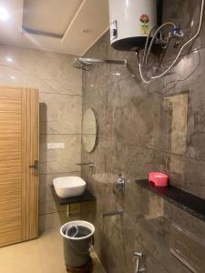 a bathroom with a toilet and a sink at HOTEL GANDHI in Alwar