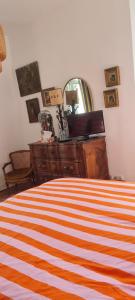 a bedroom with a bed with a dresser and a mirror at Manoir du Haut Jussé in Vezin-le-Coquet