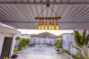 a patio with plants and a chandelier at Aravali Villa Homestay with Rooftop Jacuzzi in Udaipur
