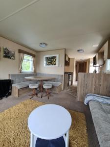 a living room with a table and a couch at Caravan Turnberry 2 in Port Seton