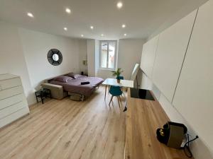 a bedroom with a bed and a desk and a table at Masha *CLIM* proche hospital in La Tronche