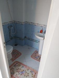 a bathroom with a toilet and a sink at Dar ettawfik in Tataouine