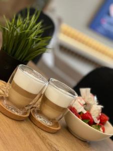 two glasses of coffee and a bowl of food on a table at Luxury apartment Old town Novi Pazar in Novi Pazar