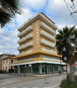 a building with a sign on the side of it at Hotel Carnaby in Rimini