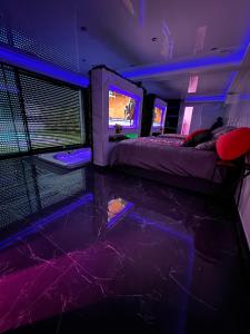 a room with two beds and a video game screen at Love Room Romantique in Villiers-sur-Marne