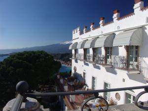 a building with balconies and a view of a river at Hotel Bel Soggiorno in Taormina