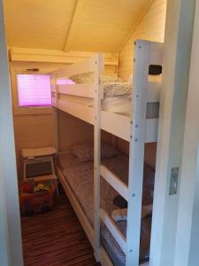 a bedroom with two bunk beds in a house at Spa Cottage Lavender in Terme Čatež in Čatež ob Savi