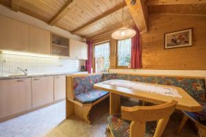 a kitchen with a table and a couch in a room at Gasthof Innerwalten in San Leonardo in Passiria