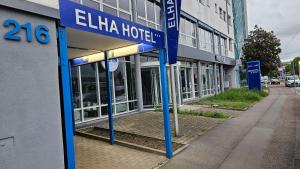 a building with blue poles in front of a building at Elha Hotel in Stuttgart