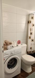 a bathroom with a washing machine and a toilet at Candy Studio Apt Marousi in Athens