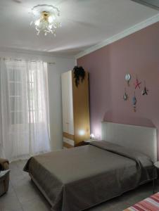 a bedroom with a bed and a chandelier at La ninfa B&B in Salerno