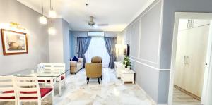 a living room with a table and chairs and a dining room at Holiday Place Kuala Lumpur in Kuala Lumpur