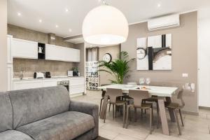 a kitchen and living room with a couch and a table at San Pietro Vatican Apartments in Rome