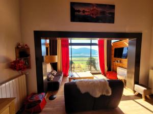 a living room with a couch and a large window at Maison - Les Angles T4 70m2 - Vue exceptionnelle in Les Angles