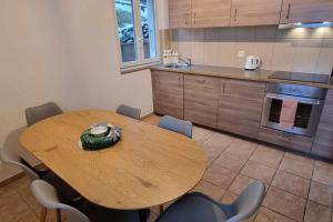 a kitchen with a wooden table and chairs in a room at Maison pour des vacances in Ayent