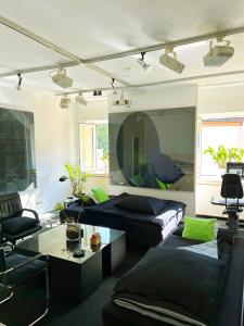 a living room with a couch and a table at Artist Residence Schwabing in Munich