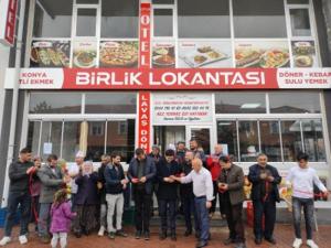 a group of people standing in front of a restaurant at Çiftlik otel in Çiftlik