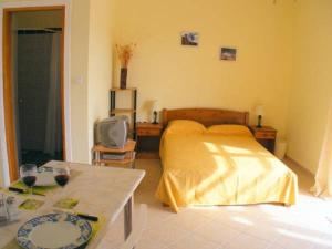 a bedroom with a bed and a table with a tv at Terramara in Nohia