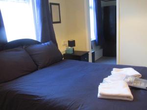 a bed with blue sheets and towels on it at No12 Guesthouse South Shore Blackpool in Blackpool