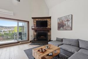 a living room with a couch and a fireplace at Tremblant Prestige - Manoir 120-6 in Mont-Tremblant