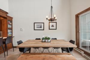 a dining room with a wooden table and chairs at Tremblant Prestige - Manoir 120-6 in Mont-Tremblant +26 photos