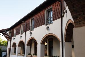 a building with arches and windows on it at La Maison de Caroline in Alba Iulia