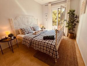 a bedroom with a white bed with a plaid blanket at Arenal Dream Javea, luxury beach apartment in Jávea