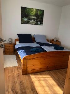 a bedroom with a wooden bed in a room at Siegen Zentral - S von eine bis zum mehrere Schlafplätze nach Wall in Siegen