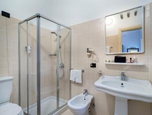 a bathroom with a shower and a toilet and a sink at Hotel Bel Soggiorno in Taormina +66 photos