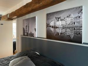 a bedroom with a large painting on the wall at Maison Gaston in Bruges