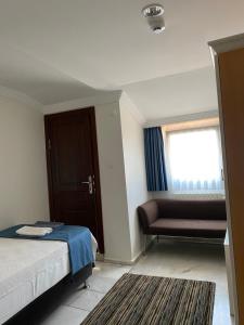 a bedroom with a bed and a chair and a window at MyKent Hotel in Istanbul