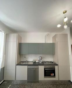 a kitchen with a sink and a stove top oven at Appartamento Sea La Vie in Genova +5 photos