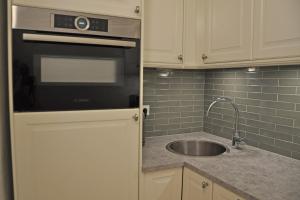 a kitchen with a sink and a stove at Apartment Austria 206 am Traunsee, Gmunden in Gmunden