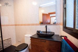a bathroom with a sink and a toilet at Casa de los hermanos in Almuñécar +21 photos