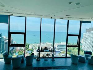 a room with a view of the ocean from a building at 2 Bed Room, Large Living Room @ Central Pattaya in Pattaya