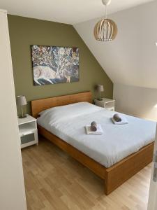 een slaapkamer met een bed met twee handdoeken erop bij Petite Opale in Ambleteuse
