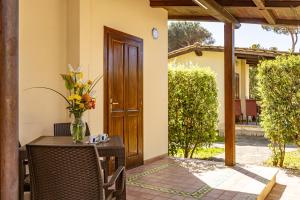 a table with a vase of flowers on a patio at Holiday Village in Fondi