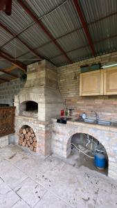 an outdoor kitchen with a stone oven in a kitchen at Holiday Home Ruben in Odzun