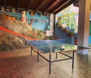 a ping pong table in a room with at Parco vacanze e appartamenti Pfirsich in Borghetto Santo Spirito