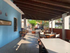 a patio with tables and chairs in a restaurant at Parco vacanze e appartamenti Pfirsich in Borghetto Santo Spirito