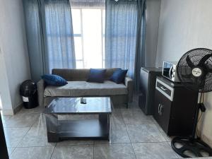 a living room with a couch and a table at Exodus Guesthouse in Driekop
