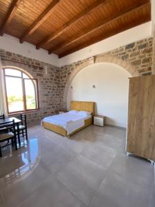 a bedroom with a bed and a table in a room at Hotel Guri Shengjin in Lezhë