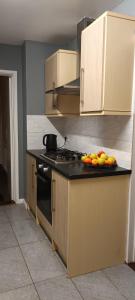 a kitchen with a counter top with fruit on it at Residence Solitaire in Woodley