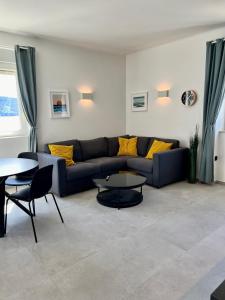 a living room with a couch and a table at Newly Refurbished Komiza Haven in Komiža