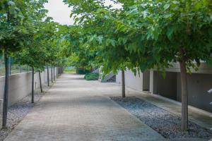a sidewalk lined with trees next to a building at Luxury Villas 3 in Nei Poroi